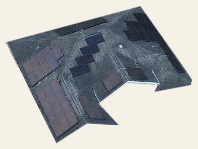 Drone view of the roof only, cut out from its surroundings: dark solar panels on gray shingles mostly on the east, west and north faces, with the stair-step four-panel south array (MP7) near the middle